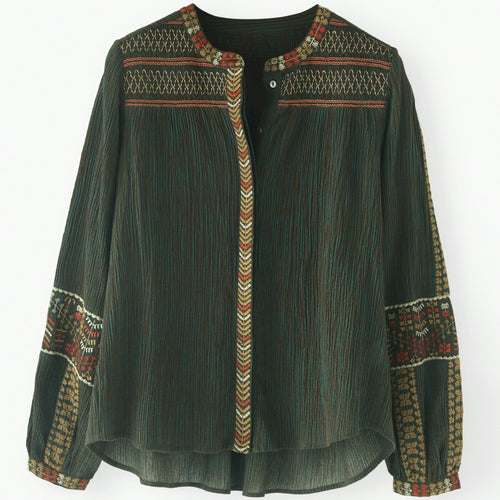 Green embroidered shirt on a white background