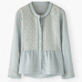 Light blue blouse with lace detailing on a white background