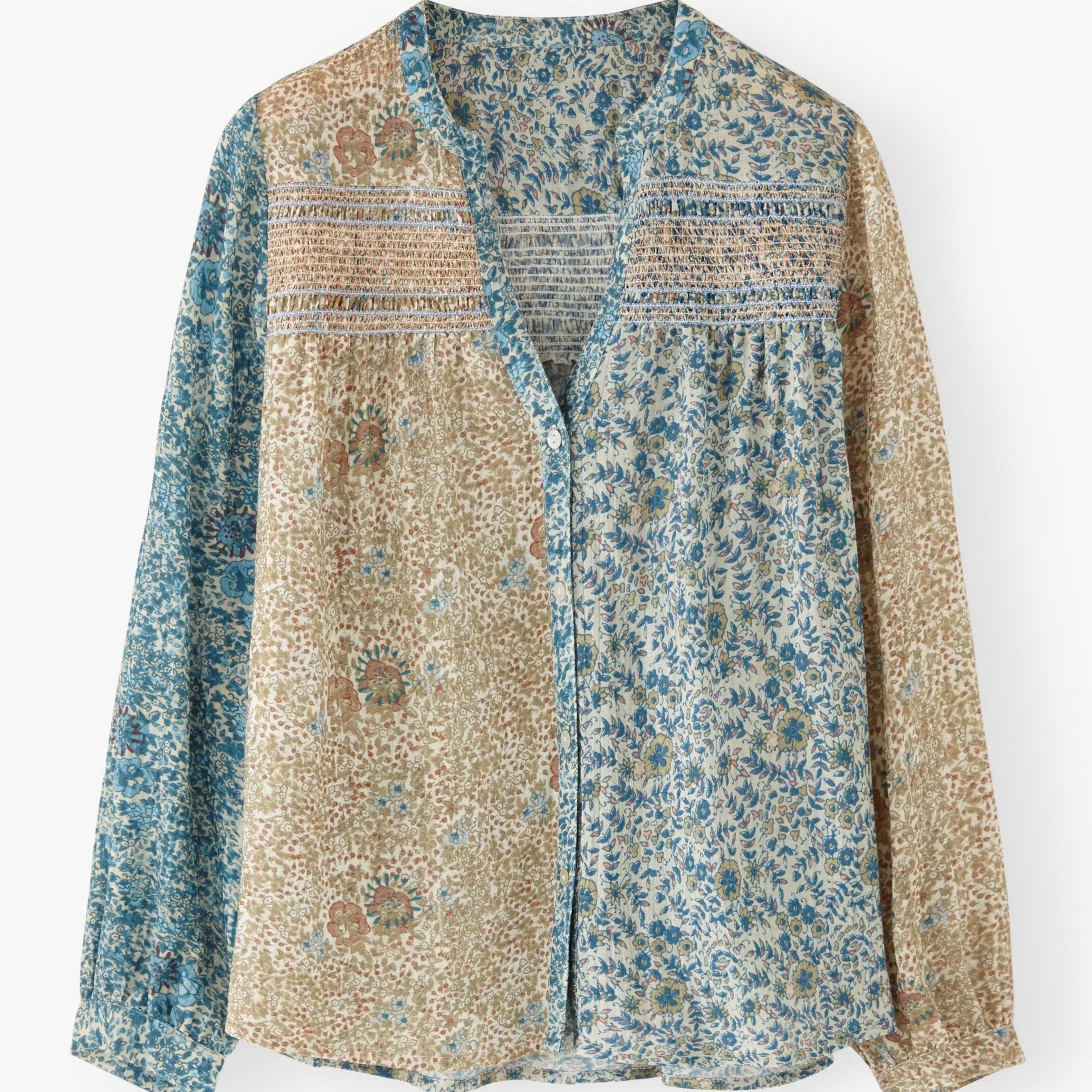 Floral patterned shirt with a mix of blue and beige colors on a white background