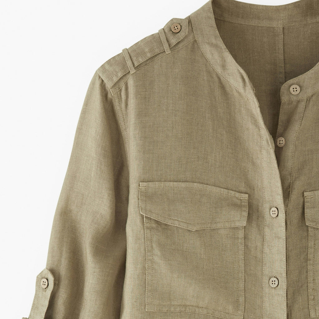 Khaki shirt with rolled-up sleeves on a white background
